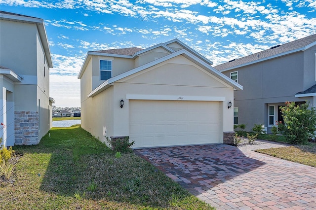 view of property with a garage and a front lawn