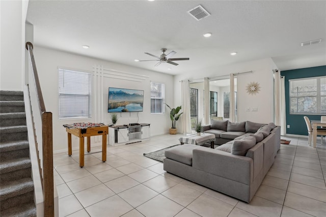 living room featuring ceiling fan, a healthy amount of sunlight, and light tile patterned floors