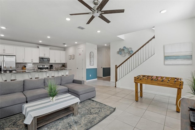 living room with ceiling fan and light tile patterned floors