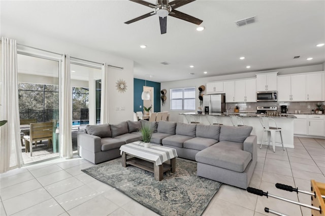 tiled living room with ceiling fan