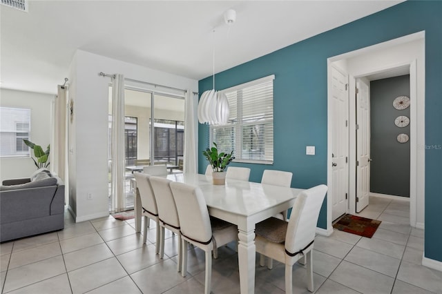 dining space featuring light tile patterned flooring