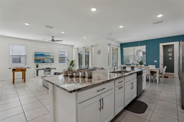 kitchen featuring sink, white cabinetry, light stone counters, an island with sink, and stainless steel appliances