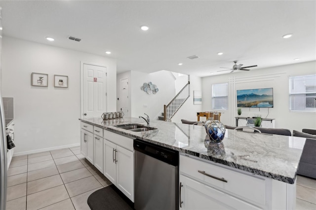 kitchen with dishwasher, white cabinetry, sink, a kitchen island with sink, and light stone counters