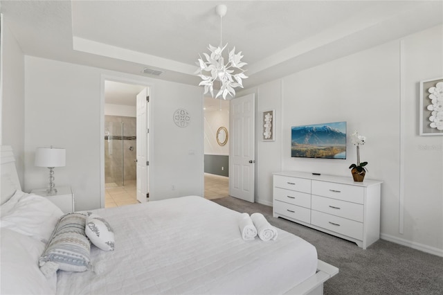 bedroom with light carpet, ensuite bath, a notable chandelier, and a raised ceiling