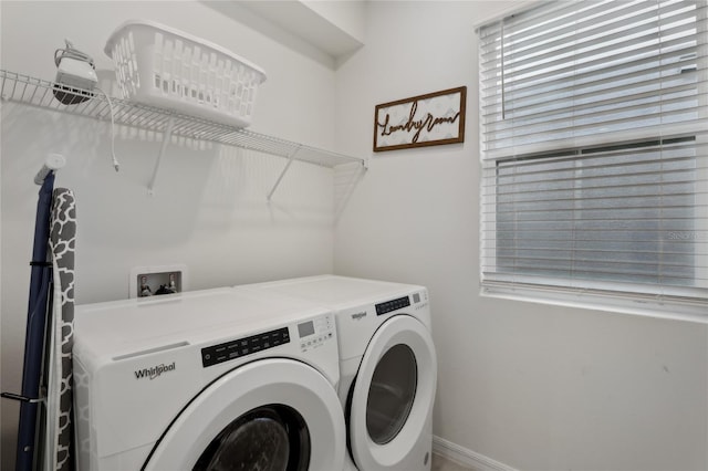 clothes washing area featuring separate washer and dryer