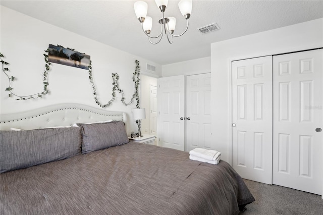 carpeted bedroom with a chandelier