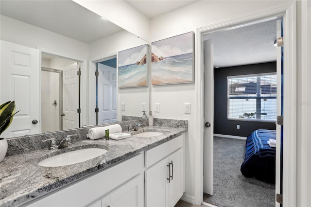 bathroom with a shower with door and vanity