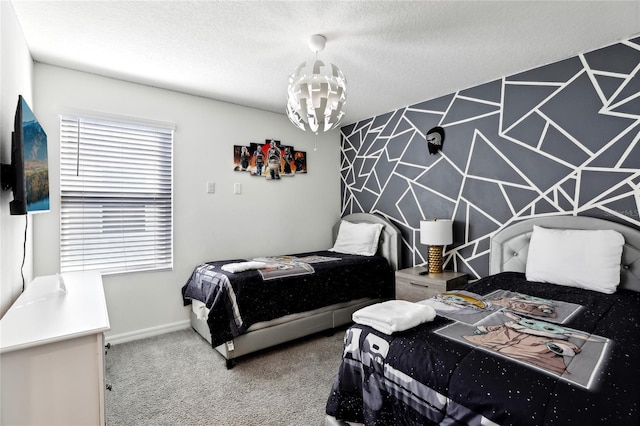 carpeted bedroom featuring a chandelier and a textured ceiling