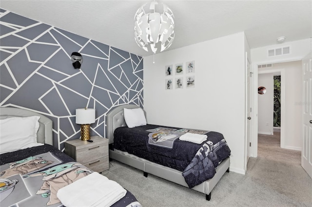 bedroom featuring an inviting chandelier and carpet floors