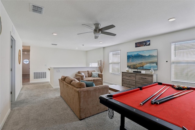 game room featuring a wealth of natural light, billiards, light carpet, and a textured ceiling