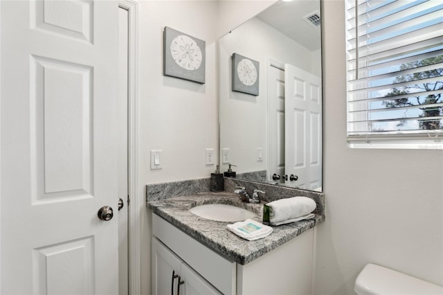 bathroom featuring vanity and toilet