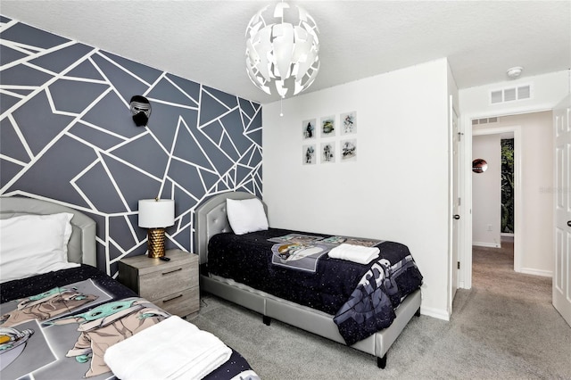 bedroom with an inviting chandelier, carpet floors, and a textured ceiling