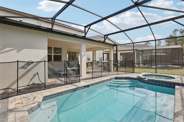 view of pool with an in ground hot tub, a patio area, and a lanai