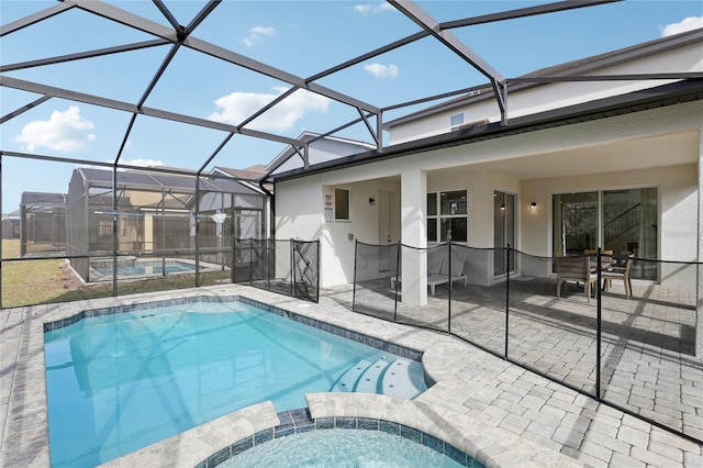 view of swimming pool featuring glass enclosure, an in ground hot tub, and a patio area