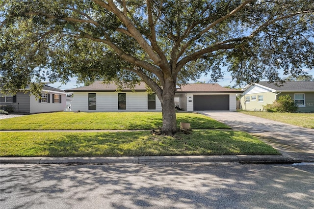 ranch-style house with a garage and a front yard