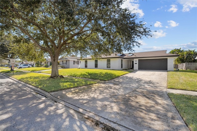 ranch-style house with a garage and a front yard