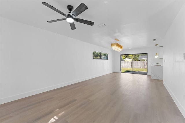 empty room featuring ceiling fan and hardwood / wood-style floors