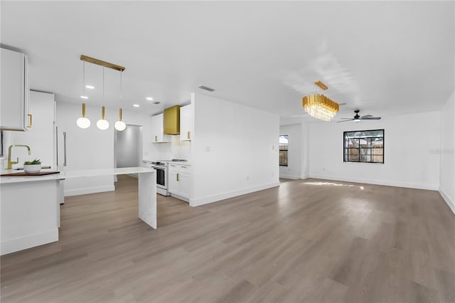 unfurnished living room featuring light wood-type flooring and ceiling fan