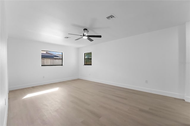 unfurnished room with ceiling fan and light wood-type flooring