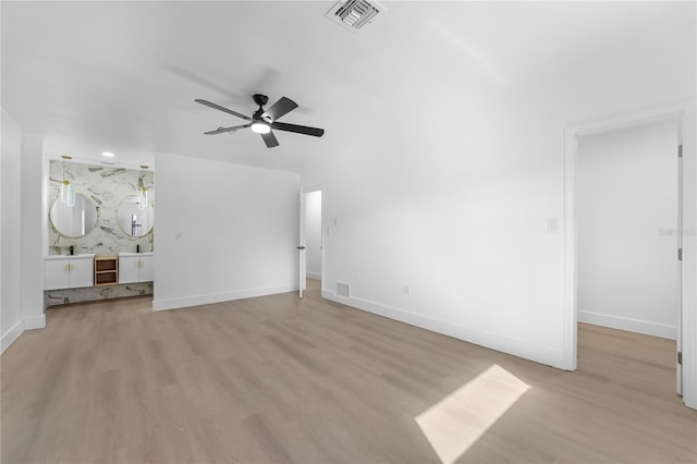 unfurnished living room with light hardwood / wood-style flooring and ceiling fan