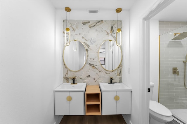 bathroom with toilet, an enclosed shower, wood-type flooring, vanity, and decorative backsplash