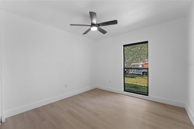 empty room with ceiling fan and light wood-type flooring