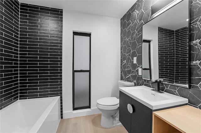 full bathroom featuring vanity, toilet, tile walls, and plus walk in shower