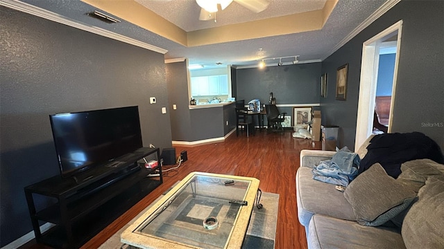 living room featuring ceiling fan, dark hardwood / wood-style floors, a raised ceiling, a textured ceiling, and track lighting