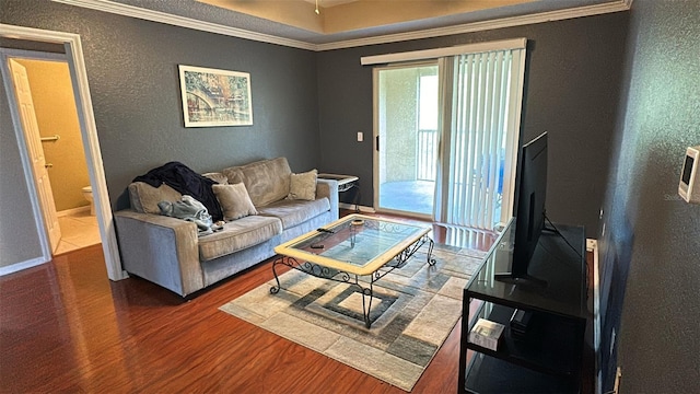 living room with dark hardwood / wood-style floors and ornamental molding