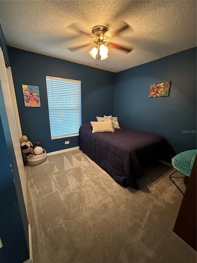 bedroom featuring ceiling fan, carpet, and a textured ceiling