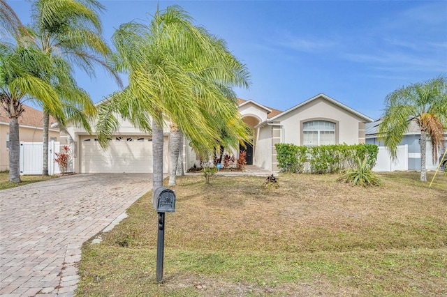 ranch-style house with a front yard and a garage