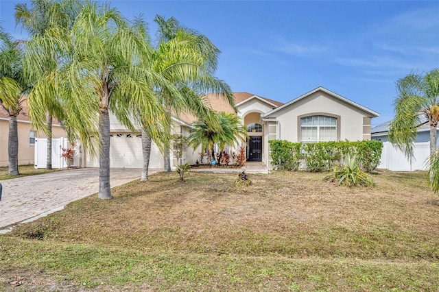 view of front of house with a front yard and a garage