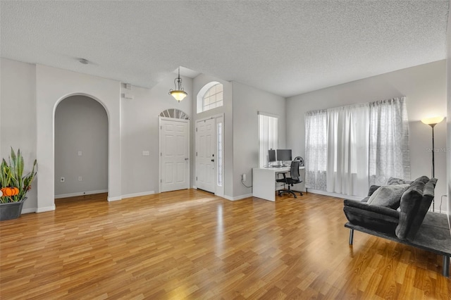 foyer entrance featuring a textured ceiling and light hardwood / wood-style flooring