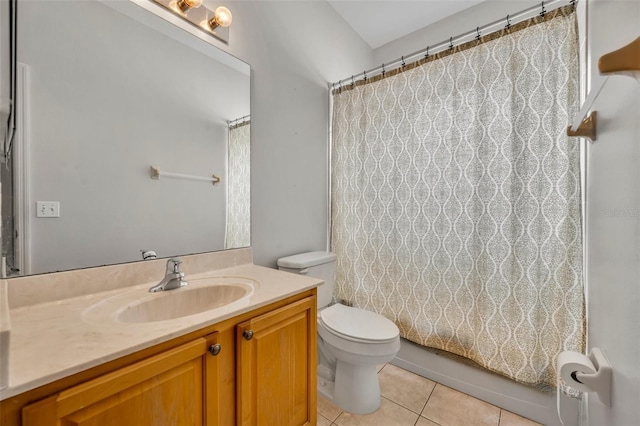 full bathroom with shower / bath combo with shower curtain, toilet, vanity, and tile patterned flooring