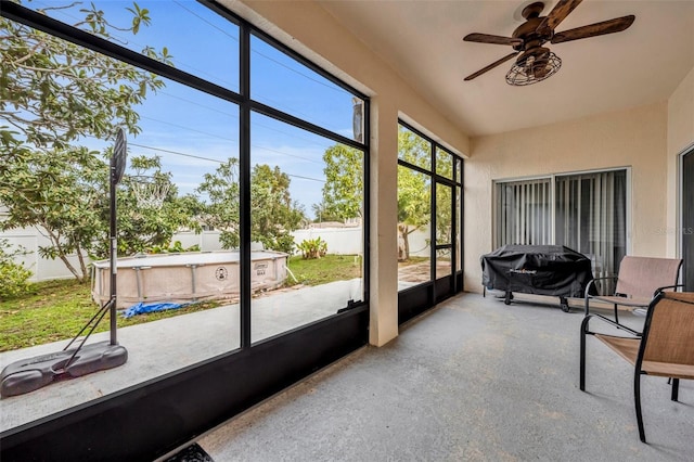 sunroom with ceiling fan and plenty of natural light