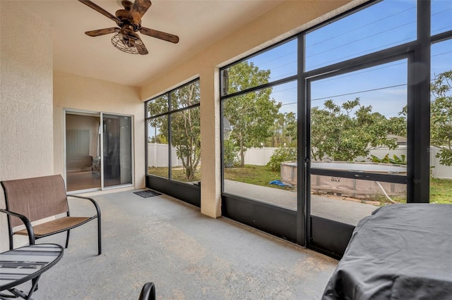 sunroom / solarium featuring ceiling fan