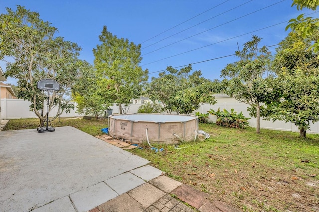 view of yard with a patio area and a fenced in pool