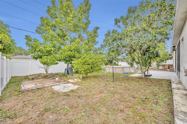 view of yard featuring a fenced in pool and a patio