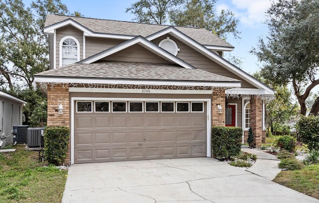 view of front facade featuring a garage and central AC