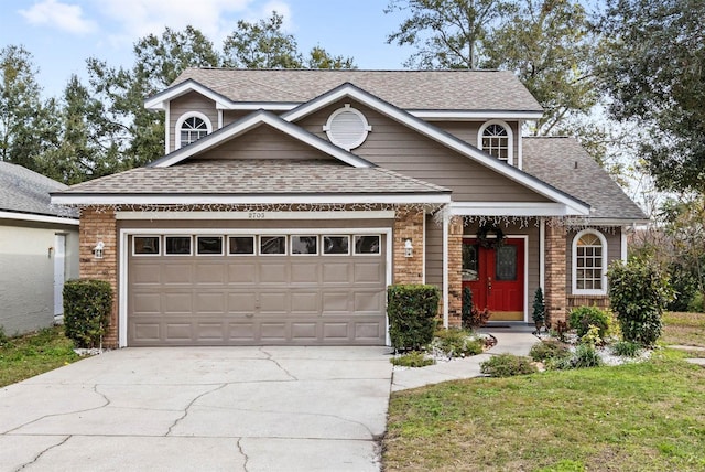 view of front of property featuring a garage and a front lawn