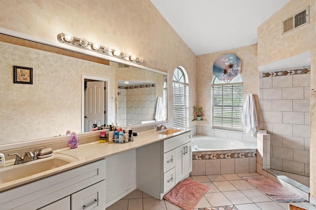 bathroom featuring vanity, vaulted ceiling, tile patterned floors, and independent shower and bath