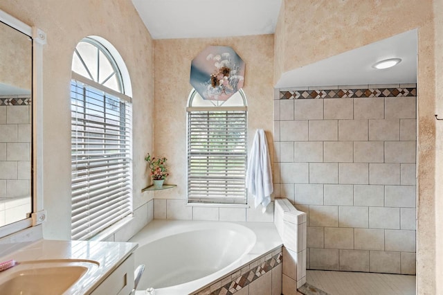 bathroom featuring vanity and shower with separate bathtub