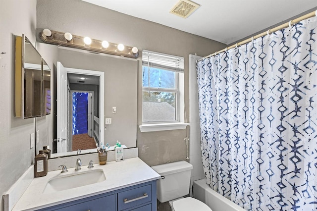 full bathroom with vanity, shower / bath combination with curtain, and toilet