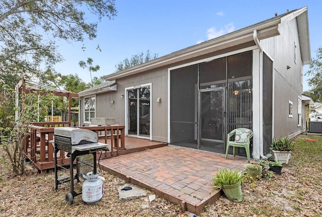 back of house featuring a sunroom and a deck