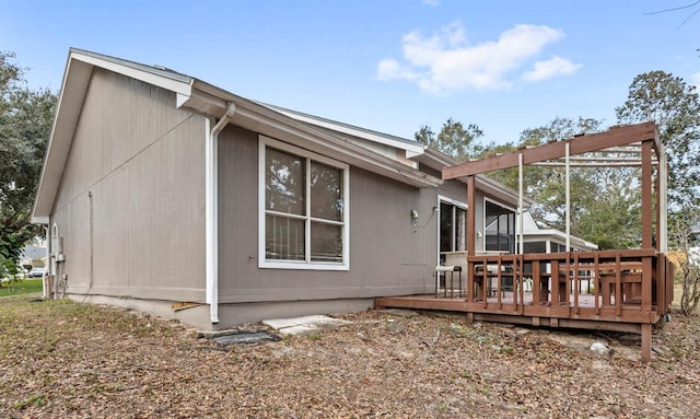 view of property exterior with a deck