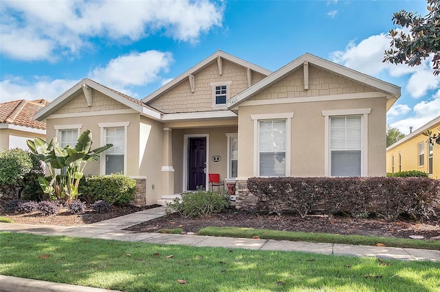 craftsman-style house with a front yard