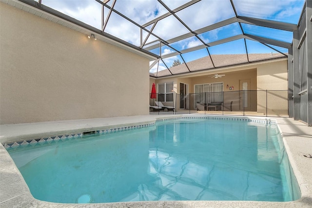 view of swimming pool with a lanai, ceiling fan, and a patio