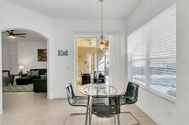 tiled dining area with ceiling fan