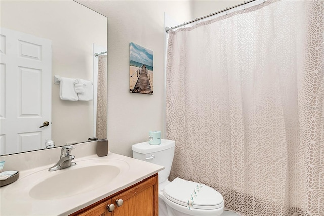 bathroom featuring toilet and vanity