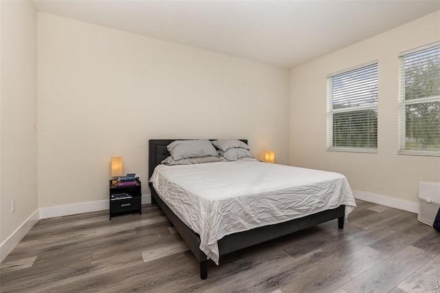 bedroom featuring dark hardwood / wood-style flooring